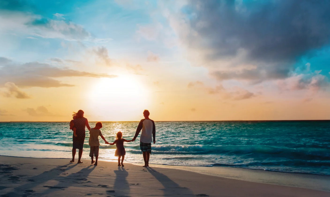 Family enjoying sunset by the sea at Pantai Cenang, Langkawi
